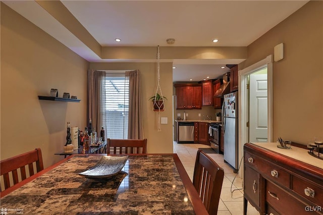 dining space featuring light tile patterned floors and sink