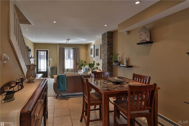 dining area with a baseboard radiator and light tile patterned flooring