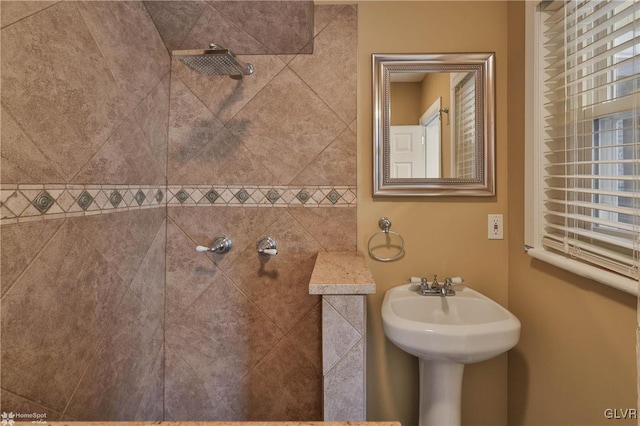 bathroom with a tile shower