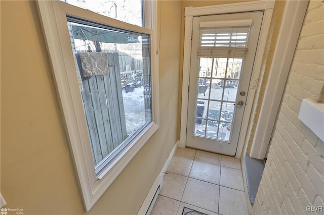 doorway to outside with light tile patterned floors and brick wall