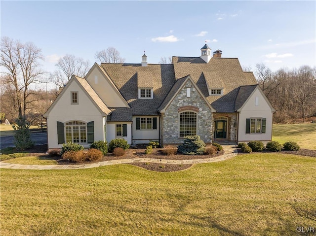 french provincial home with a front yard