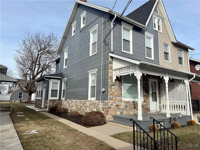 view of side of home with a porch