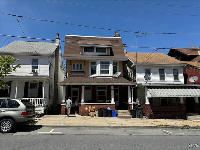 view of front of home with cooling unit and a porch