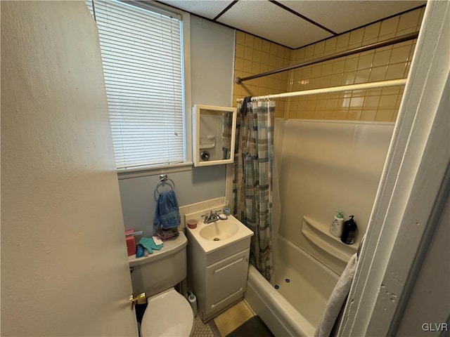 bathroom with a paneled ceiling, curtained shower, vanity, and toilet