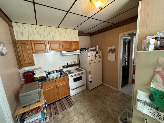 kitchen featuring a paneled ceiling, sink, and white appliances