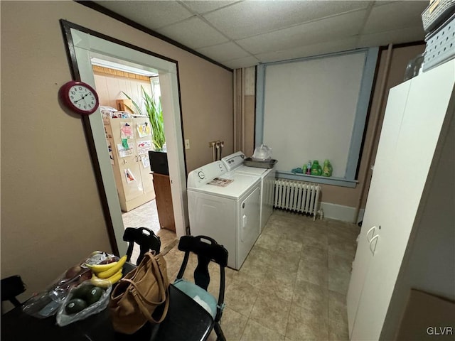 washroom with radiator and washing machine and clothes dryer