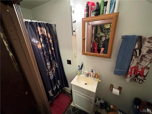 bathroom with curtained shower and vanity