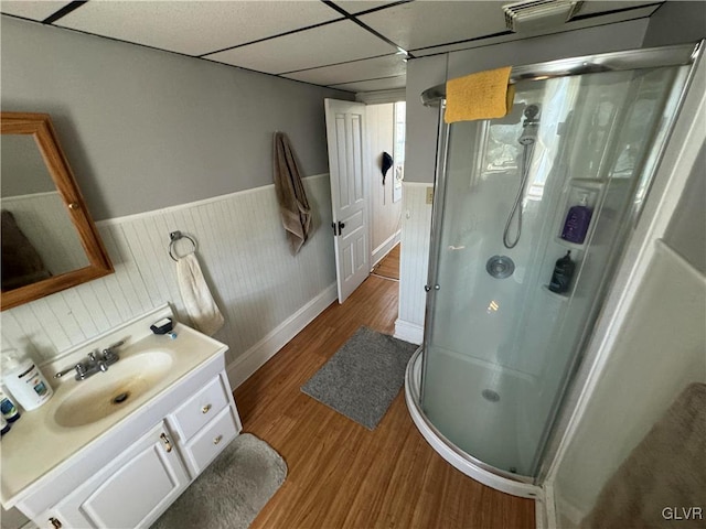 bathroom featuring a paneled ceiling, vanity, an enclosed shower, and wood-type flooring