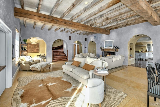 living room with brick ceiling and beamed ceiling