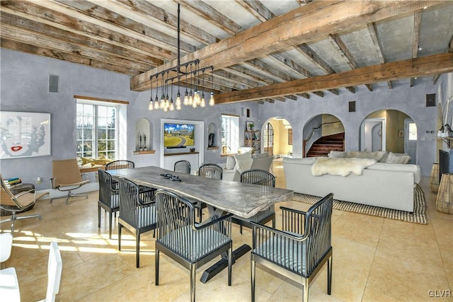 dining space featuring beam ceiling