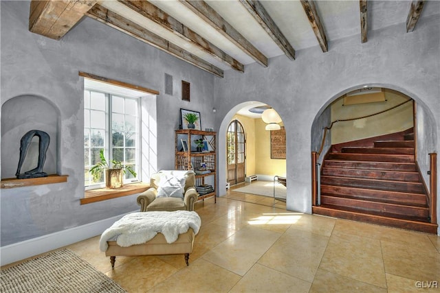 living area featuring beamed ceiling