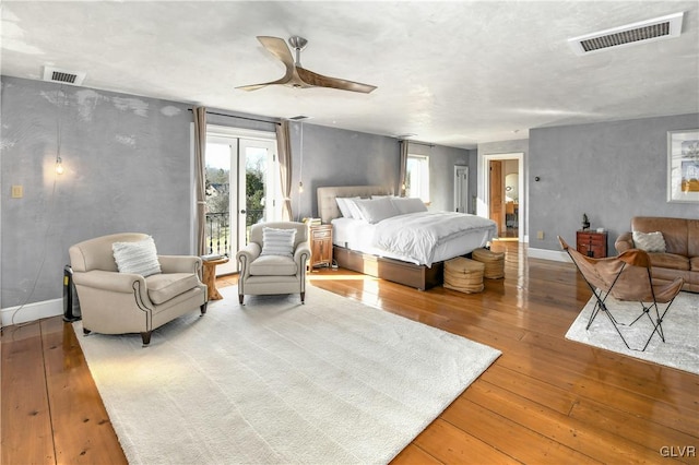 bedroom featuring access to exterior, wood-type flooring, and ceiling fan