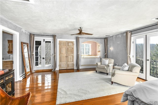 interior space featuring ceiling fan, french doors, and hardwood / wood-style floors