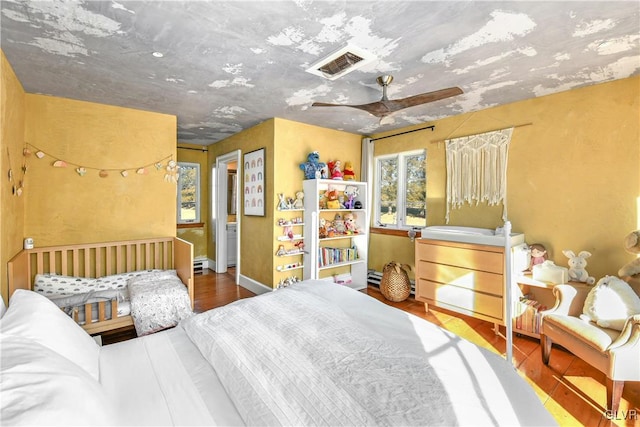 bedroom with ceiling fan and hardwood / wood-style flooring