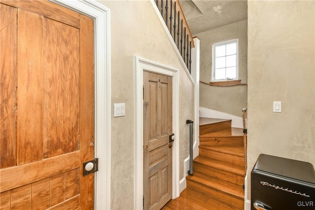 stairs featuring hardwood / wood-style flooring