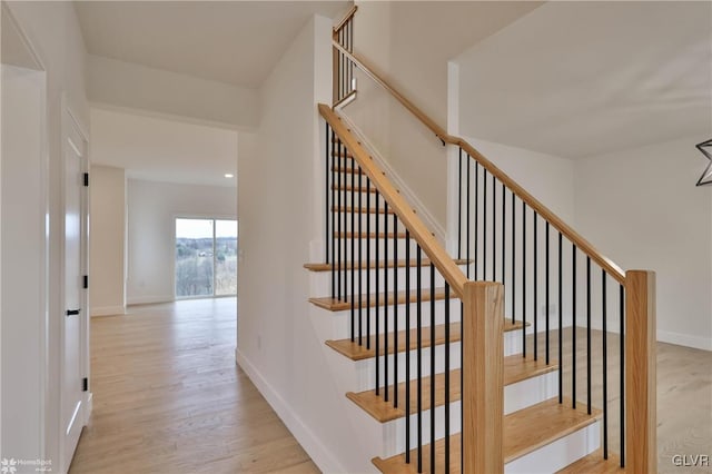 stairs featuring hardwood / wood-style floors