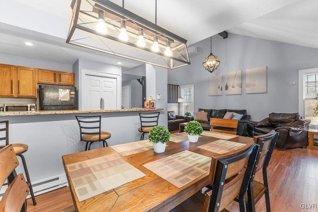 dining space featuring sink, a baseboard radiator, dark hardwood / wood-style floors, and an inviting chandelier