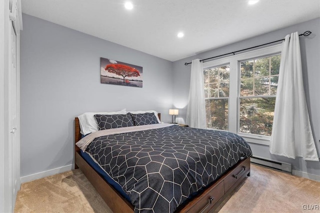 bedroom featuring light carpet and a baseboard radiator