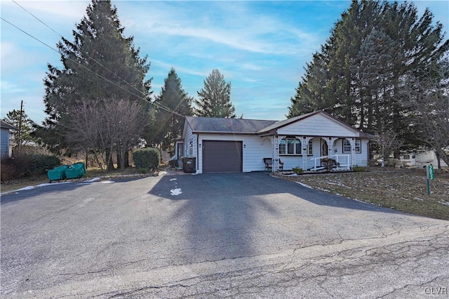 ranch-style house featuring a garage and a porch