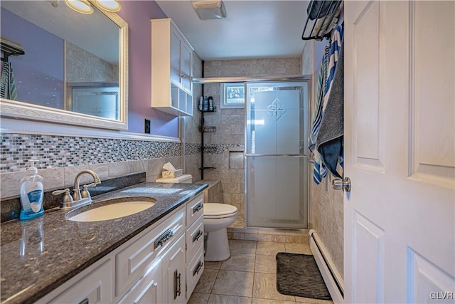 bathroom featuring vanity, a shower with door, tile patterned floors, and a baseboard radiator