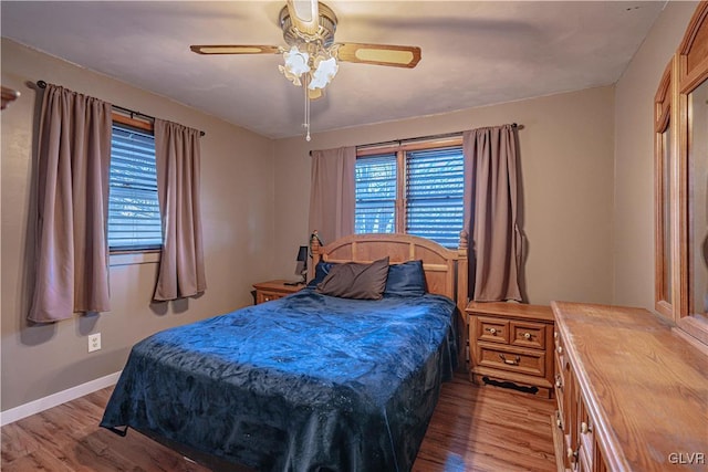 bedroom with ceiling fan and light hardwood / wood-style floors