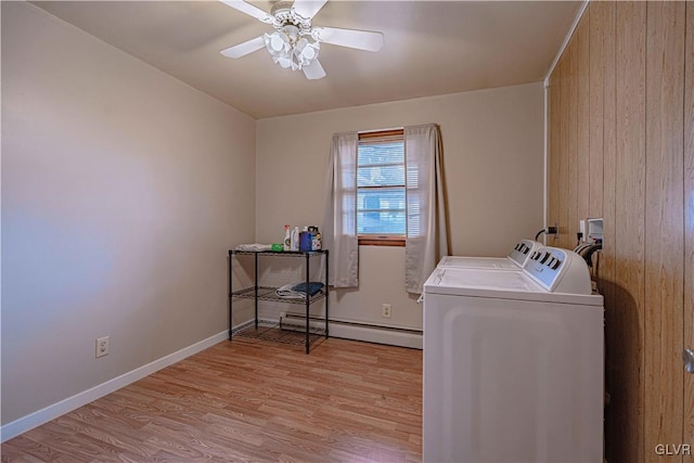 washroom with light hardwood / wood-style floors, wood walls, ceiling fan, washer and dryer, and a baseboard radiator