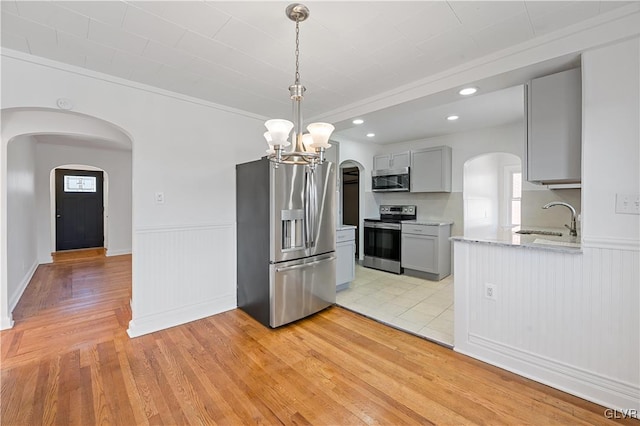 kitchen featuring appliances with stainless steel finishes, gray cabinets, plenty of natural light, and sink