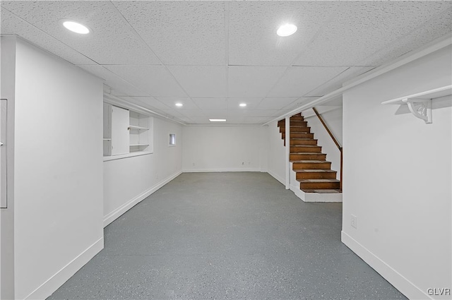 basement with a paneled ceiling