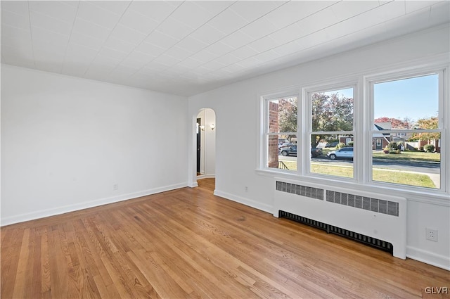 empty room featuring light hardwood / wood-style floors and radiator