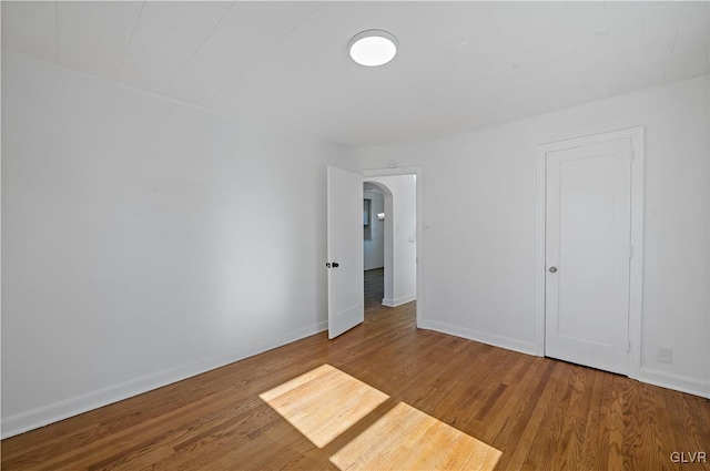 empty room with wood-type flooring