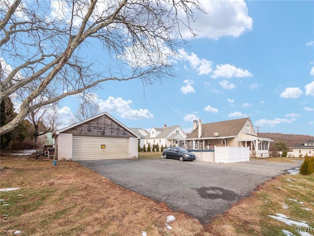 view of side of property featuring a garage and an outdoor structure