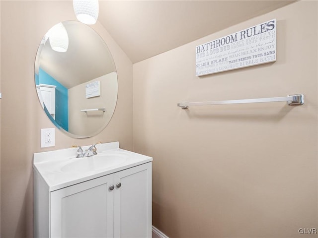 bathroom with vanity and lofted ceiling