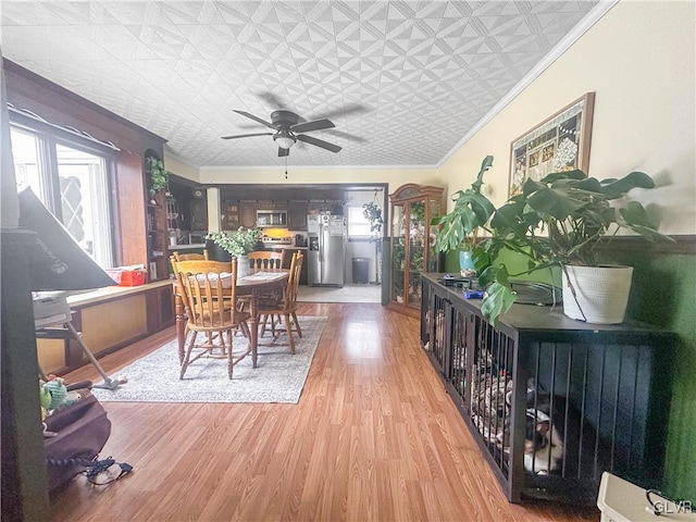 dining area featuring ceiling fan, hardwood / wood-style floors, and ornamental molding