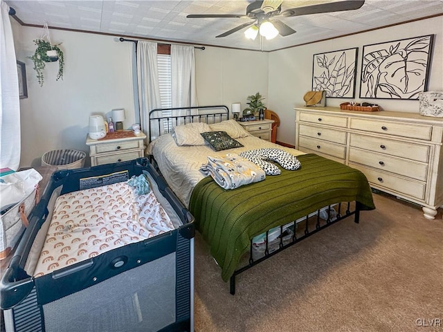 bedroom featuring carpet, ceiling fan, and crown molding