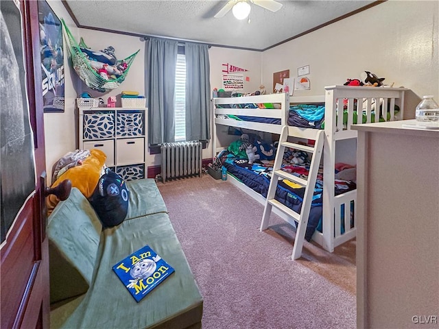 carpeted bedroom featuring a textured ceiling, radiator, ornamental molding, and ceiling fan