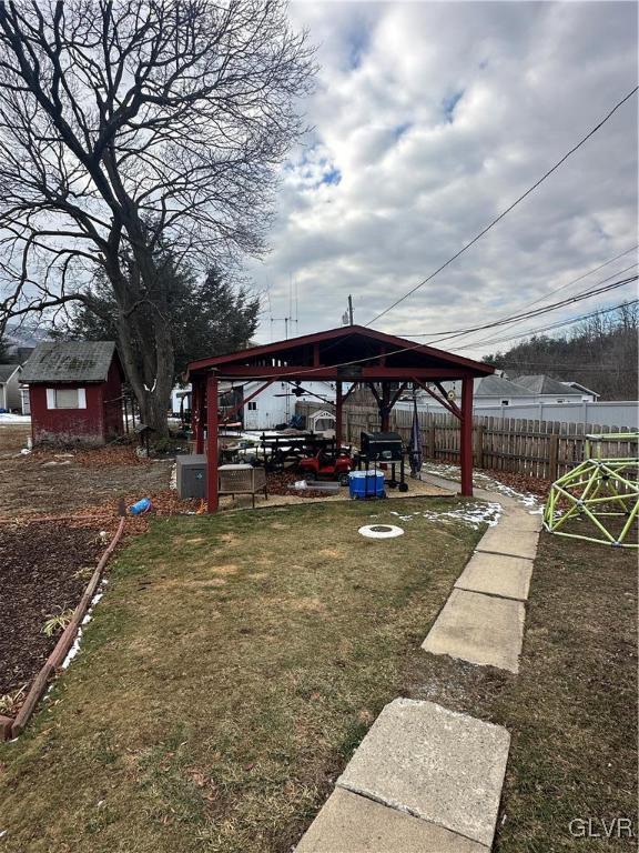 view of yard with a gazebo and an outbuilding