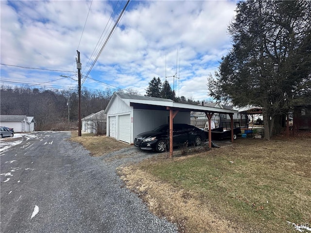 exterior space with a garage, an outdoor structure, and a carport