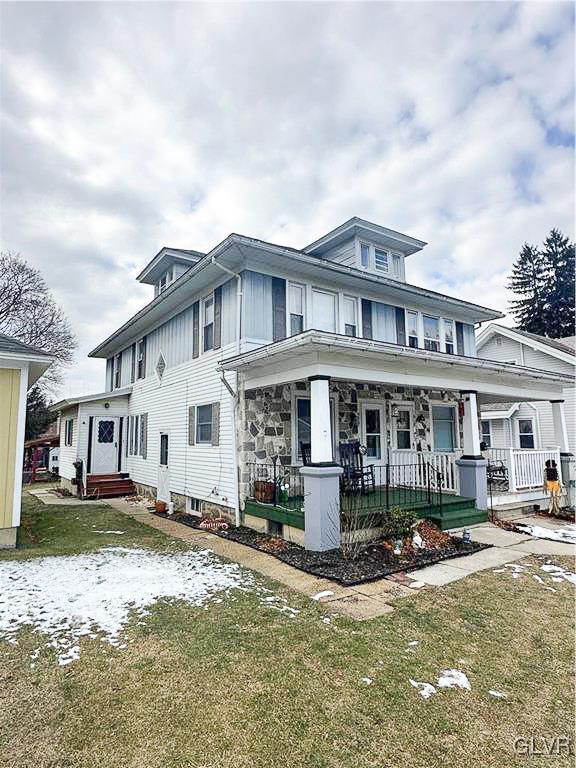 view of front of home featuring a front yard and a porch