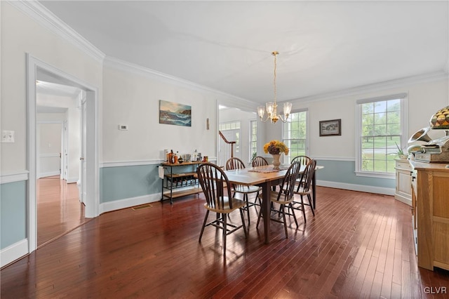 dining area with a notable chandelier, crown molding, and dark wood-type flooring