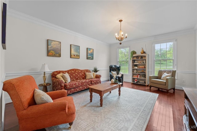 living room featuring a notable chandelier, dark hardwood / wood-style floors, and crown molding