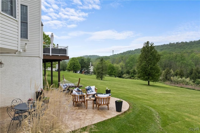 view of yard with a patio area and a balcony