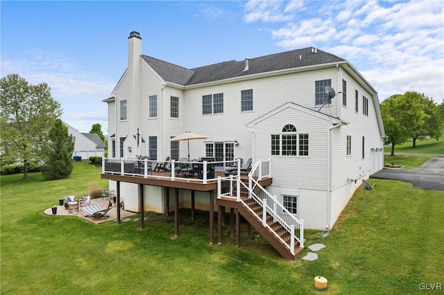 back of property featuring a patio, a deck, and a lawn