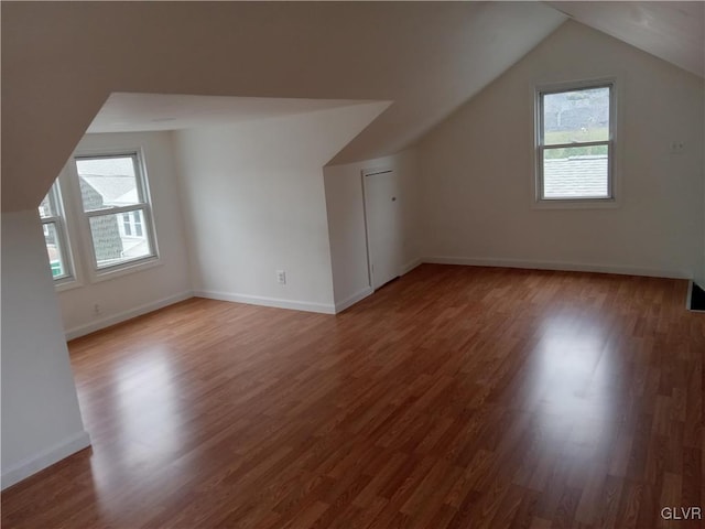 bonus room with a healthy amount of sunlight, vaulted ceiling, and hardwood / wood-style flooring