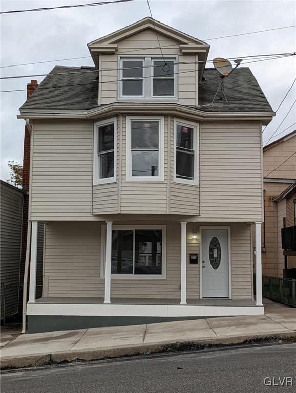 view of front property featuring covered porch