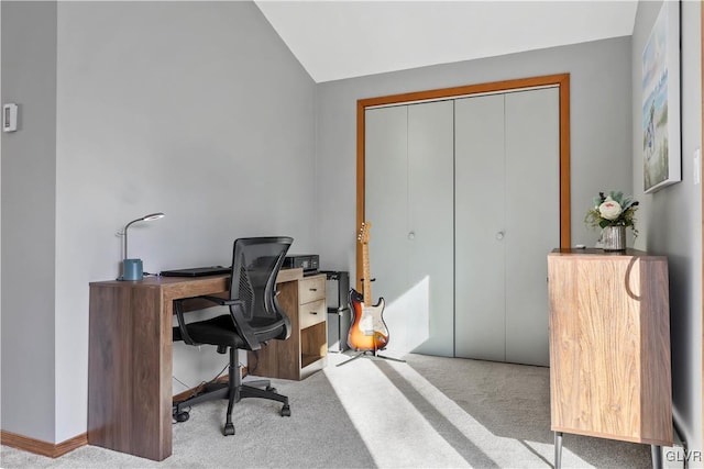 office space with light colored carpet and vaulted ceiling