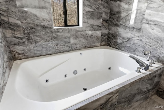 bathroom with a relaxing tiled tub