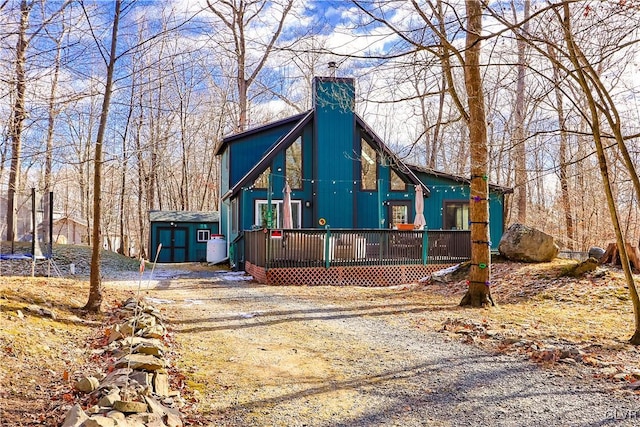 back of house featuring a wooden deck