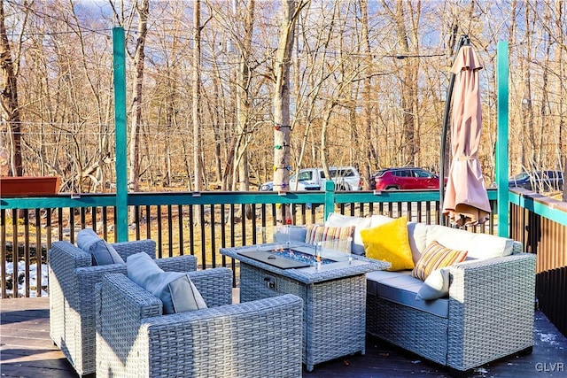 wooden deck with an outdoor living space with a fire pit