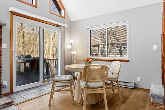 dining area featuring light hardwood / wood-style floors and vaulted ceiling