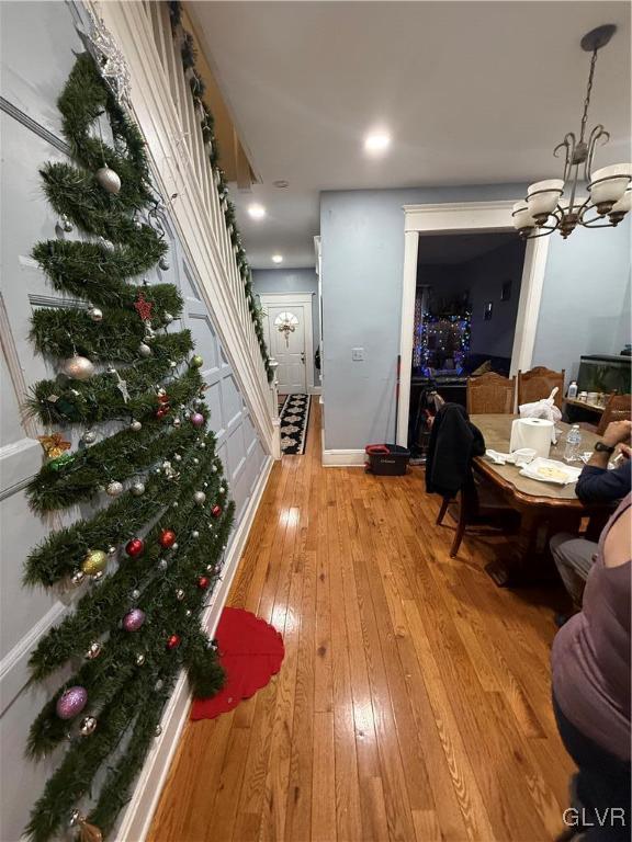 dining space featuring an inviting chandelier and light hardwood / wood-style flooring